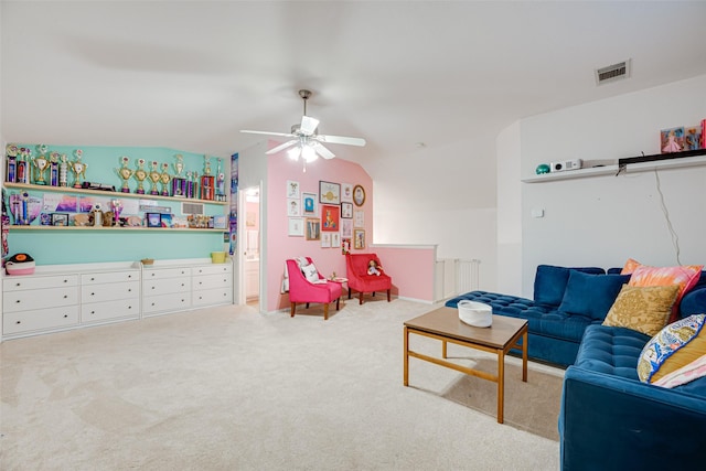 living room with ceiling fan, light colored carpet, and lofted ceiling