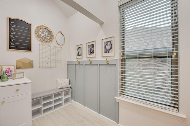 mudroom featuring light hardwood / wood-style floors and vaulted ceiling