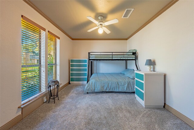 bedroom with carpet flooring, ceiling fan, and crown molding