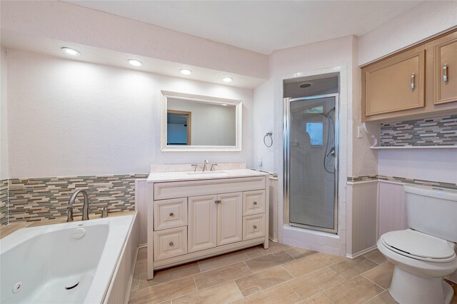 full bathroom with vanity, toilet, and independent shower and bath