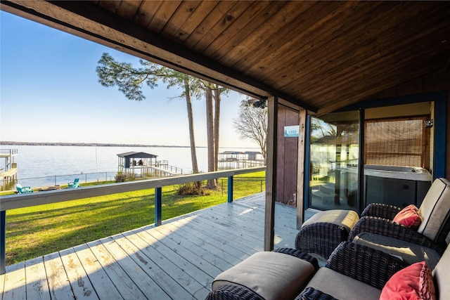 wooden terrace featuring a water view