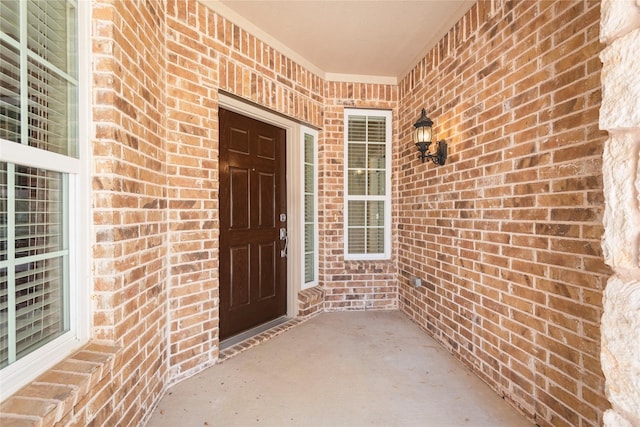 doorway to property with brick siding