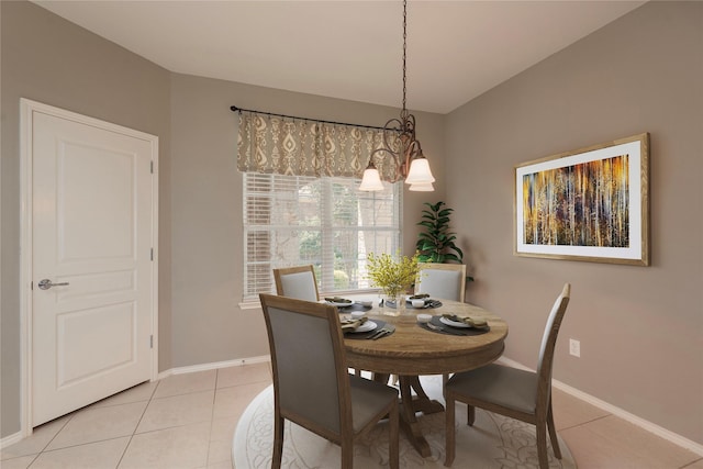 tiled dining area with an inviting chandelier