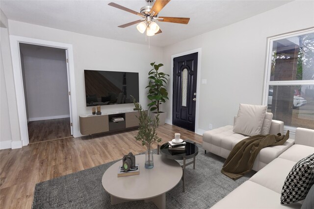 living room with hardwood / wood-style flooring and ceiling fan