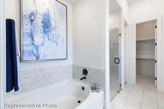 bathroom featuring separate shower and tub