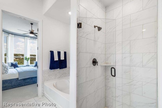 bathroom featuring ceiling fan and plus walk in shower