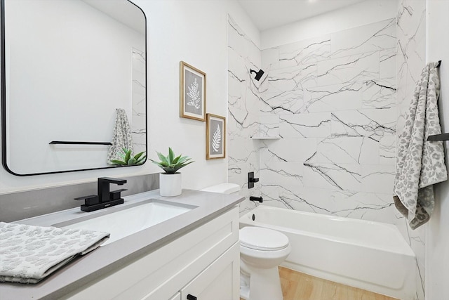 full bathroom featuring vanity, toilet, tiled shower / bath combo, and hardwood / wood-style floors