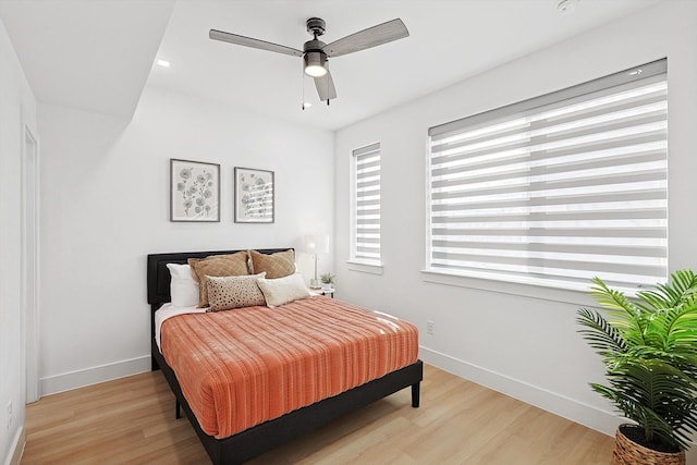 bedroom with ceiling fan and light wood-type flooring