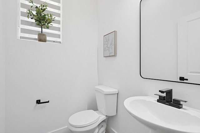 bathroom with toilet and sink