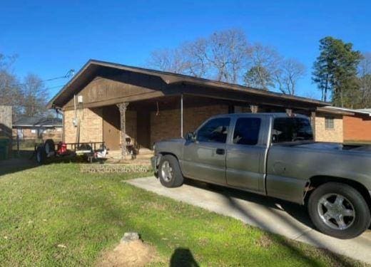 view of property exterior with a lawn and a carport