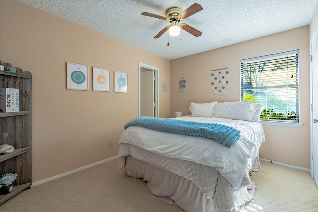 carpeted bedroom featuring a textured ceiling and ceiling fan