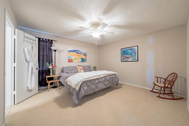 carpeted bedroom featuring ceiling fan and a textured ceiling