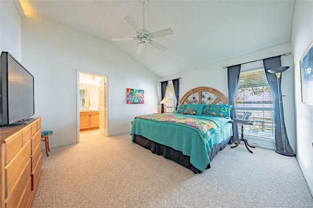 bedroom with ceiling fan, ensuite bathroom, a textured ceiling, vaulted ceiling, and light carpet