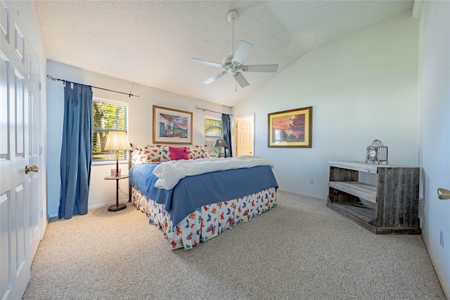 bedroom featuring ceiling fan, vaulted ceiling, light colored carpet, and a textured ceiling