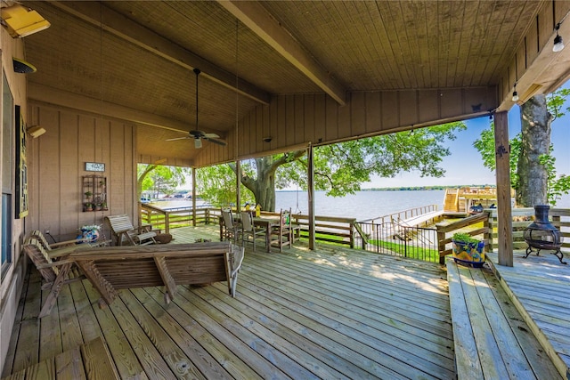 wooden terrace with ceiling fan and a water view