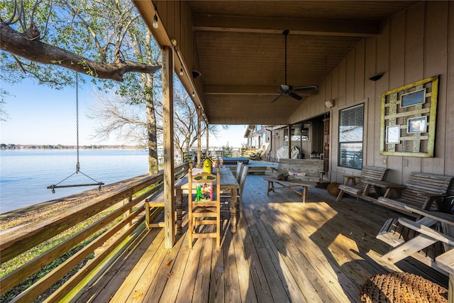 wooden deck featuring ceiling fan and a water view