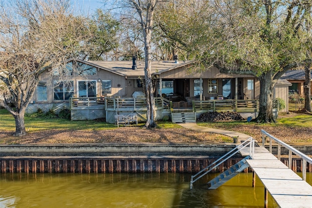 back of house with a water view