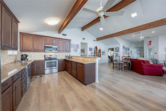 kitchen with sink, vaulted ceiling with beams, decorative backsplash, kitchen peninsula, and stainless steel appliances