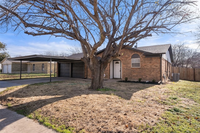 ranch-style home featuring a garage, a carport, and central air condition unit