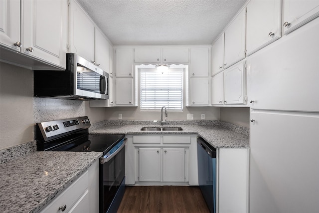 kitchen featuring white cabinets, appliances with stainless steel finishes, dark hardwood / wood-style flooring, and sink