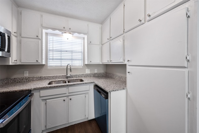 kitchen featuring dark wood-type flooring, white cabinets, sink, a textured ceiling, and stainless steel appliances