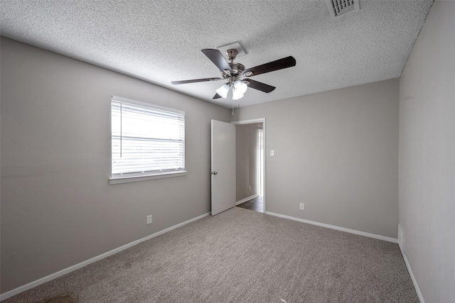 unfurnished room featuring ceiling fan, carpet, and a textured ceiling