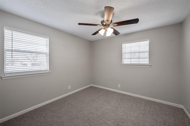 carpeted spare room with ceiling fan and a textured ceiling