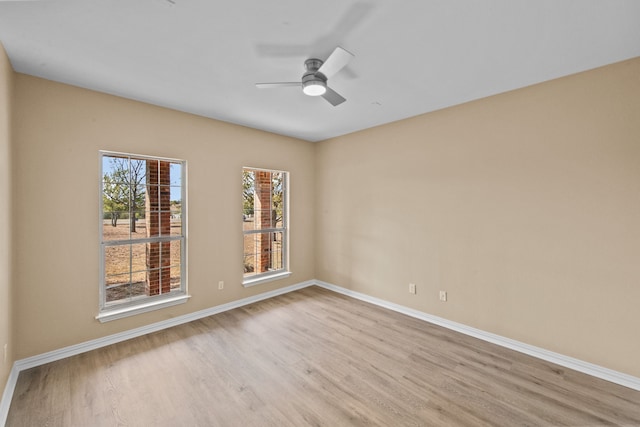 unfurnished room with ceiling fan and light hardwood / wood-style flooring