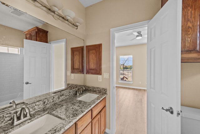 bathroom featuring ceiling fan, vanity, wood-type flooring, and toilet