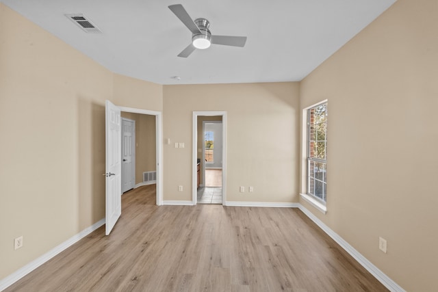 empty room with ceiling fan and light wood-type flooring