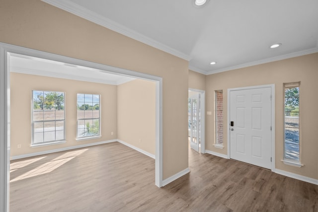 foyer entrance featuring light wood-type flooring and ornamental molding