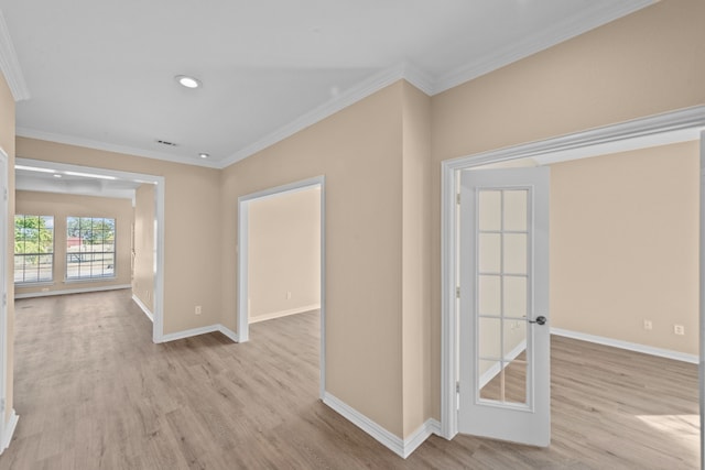 hall with french doors, ornamental molding, and light hardwood / wood-style floors