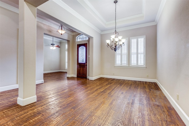 entryway featuring a tray ceiling, crown molding, dark wood-type flooring, and ceiling fan with notable chandelier