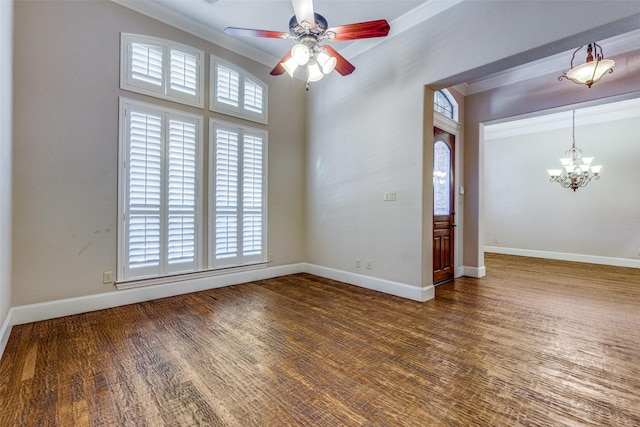 spare room with ceiling fan with notable chandelier, hardwood / wood-style flooring, and crown molding