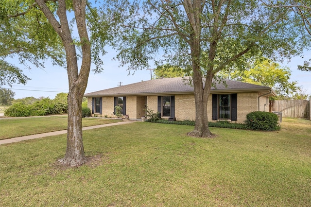 ranch-style home with a front lawn