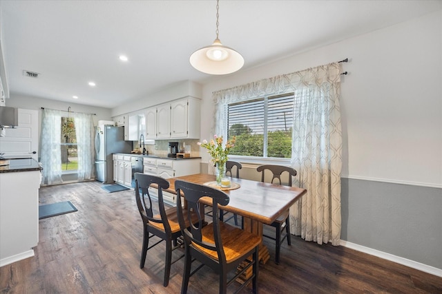 dining area with dark wood-type flooring and sink