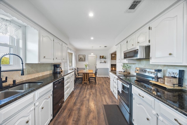 kitchen featuring stainless steel appliances, white cabinetry, sink, and a wealth of natural light