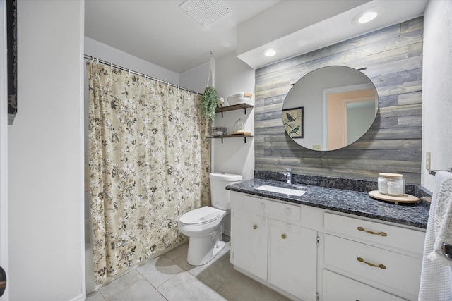 bathroom with vanity, tile patterned flooring, curtained shower, and toilet