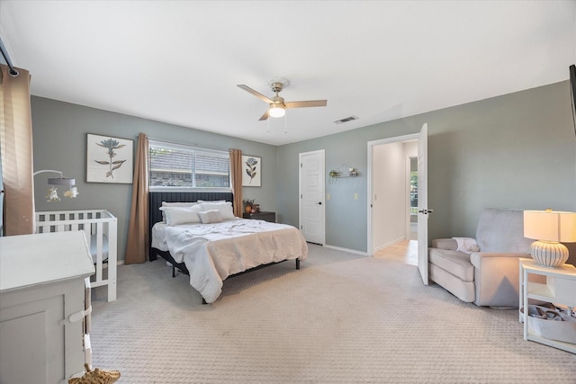 bedroom with ceiling fan and light colored carpet