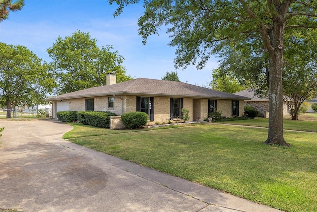 ranch-style home with a garage and a front yard