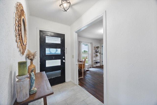 tiled foyer with crown molding