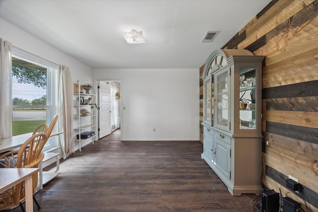 dining area featuring dark hardwood / wood-style floors and a textured ceiling