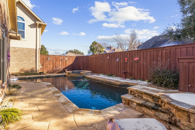 view of swimming pool featuring an in ground hot tub and a patio