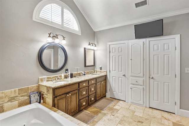 bathroom featuring ornamental molding, vanity, a tub, and lofted ceiling