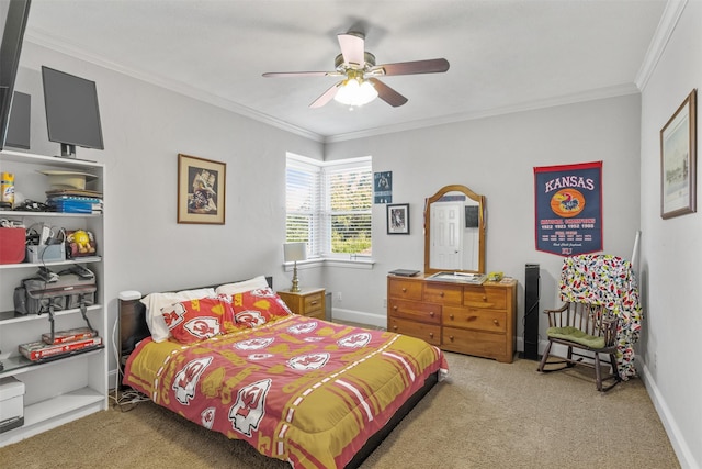 carpeted bedroom with ceiling fan and ornamental molding