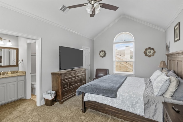 carpeted bedroom with ceiling fan, lofted ceiling, ornamental molding, and connected bathroom