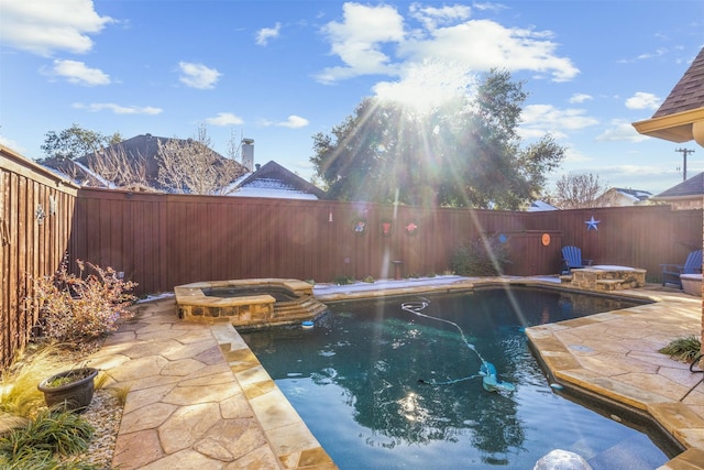 view of pool with a patio area and an in ground hot tub