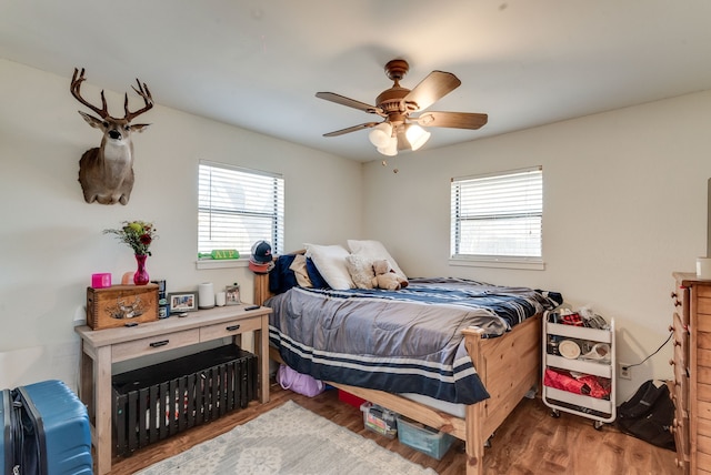 bedroom with dark wood-type flooring and ceiling fan