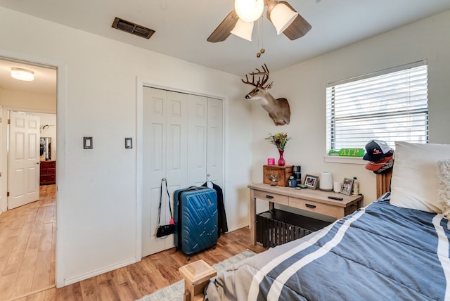 bedroom featuring light hardwood / wood-style flooring, a closet, and ceiling fan