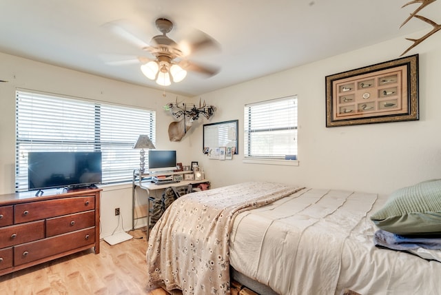 bedroom featuring multiple windows, ceiling fan, and light wood-type flooring